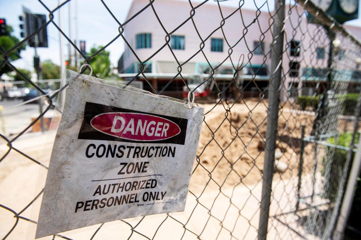A sign warning of potential danger, hangs on a fence as construction continues at Bob Hart Square in Merced, Calif., on Friday, May 16, 2025. According to the City of Merced, the renovation to the square will include an extended plaza-like design, the addition of trees, a seating area and a stage.