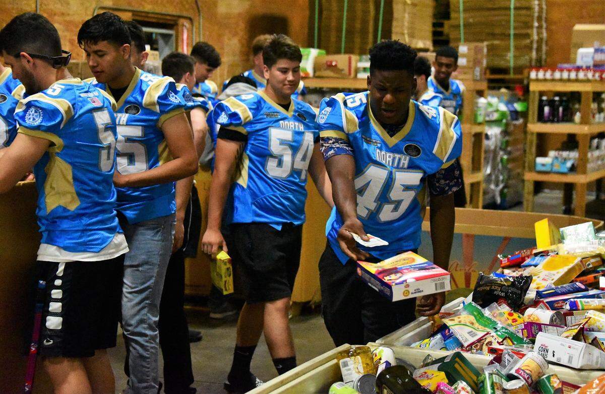Former Golden Valley football player Davon Johnson, 45, donated some of his time, along with some of his South teammates to help sort food at the Merced County Food Bank on Tuesday, Aug. 18, 2019.