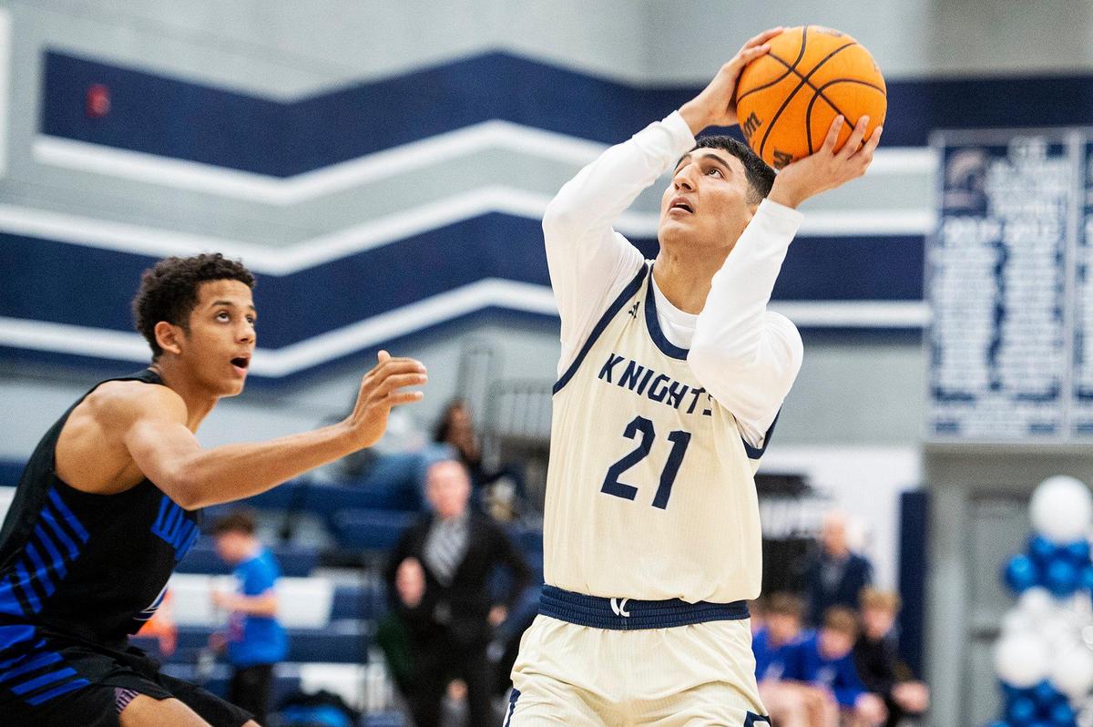 Stone Ridge Christian senior Brock Richards (21) spins toward the basket during a CIF Sac-Joaquin Section Division 6 playoff game against Sacramento Waldorf at Stone Ridge Christian High School in Merced, Calif., on Tuesday, Feb. 20, 2024. The Knights beat the Wave 50-37.