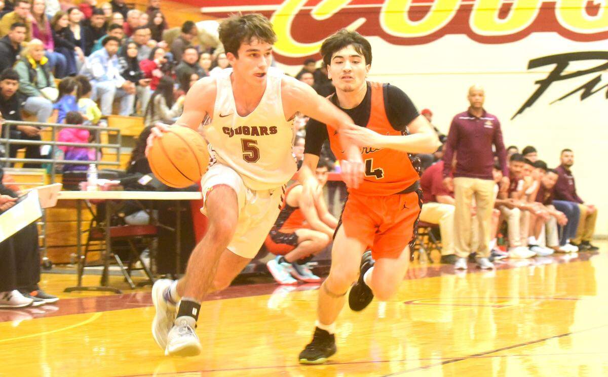 Golden Valley High School senior Joey Spielman (5) drives to the basket as Merced sophomore Keaton Hillyer (4) defends during a basketball game on Wednesday, Jan. 3, 2023 at Cougar Arena.