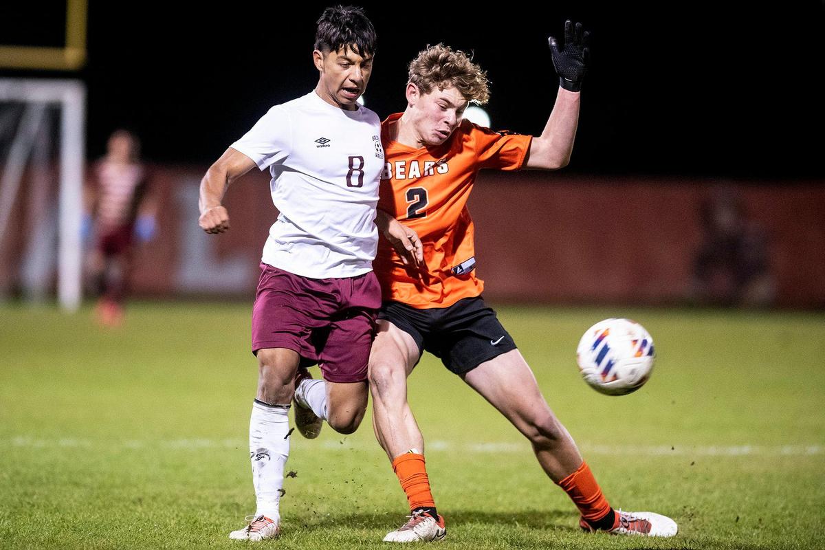 Golden Valley senior Giovanny Ramirez (8) and Merced senior Logan Harsh (2) battle for possession of the ball during a game at Merced High School in Merced, Calif., on Thursday, Jan. 11, 2024. The Cougars beat the Bears 3-1.