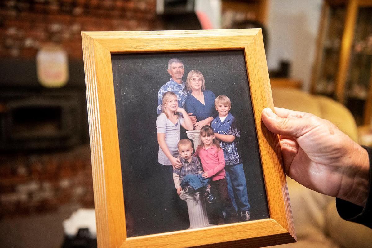 Bob Edwards, 76, holds a photo of he and wife Billie Edwards with grandchildren, at their home in Atwater, Calif., on Thursday, Nov. 3, 2022. Family members said Edwards, 73, and her sister Carolyn Rose, 76, were walking along East Juniper Avenue on Nov. 2, when they were struck and killed by a vehicle. Authorities said the vehicle was traveling westbound on East Juniper Avenue when it left the roadway striking the women and a light pole.