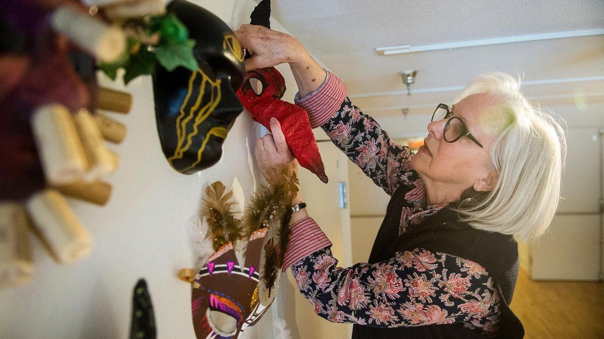 Merced Multicultural Arts Center board member Cheryl Barnett, hangs Mardi Gras masks on a wall ahead of the Mardi Gras at the Mac event, at the Merced Multicultural Arts Center in downtown Merced, Calif., on Thursday, Feb. 20, 2020. The event will take place on Friday, Feb. 21, from 5:30 p.m. to 10 p.m..