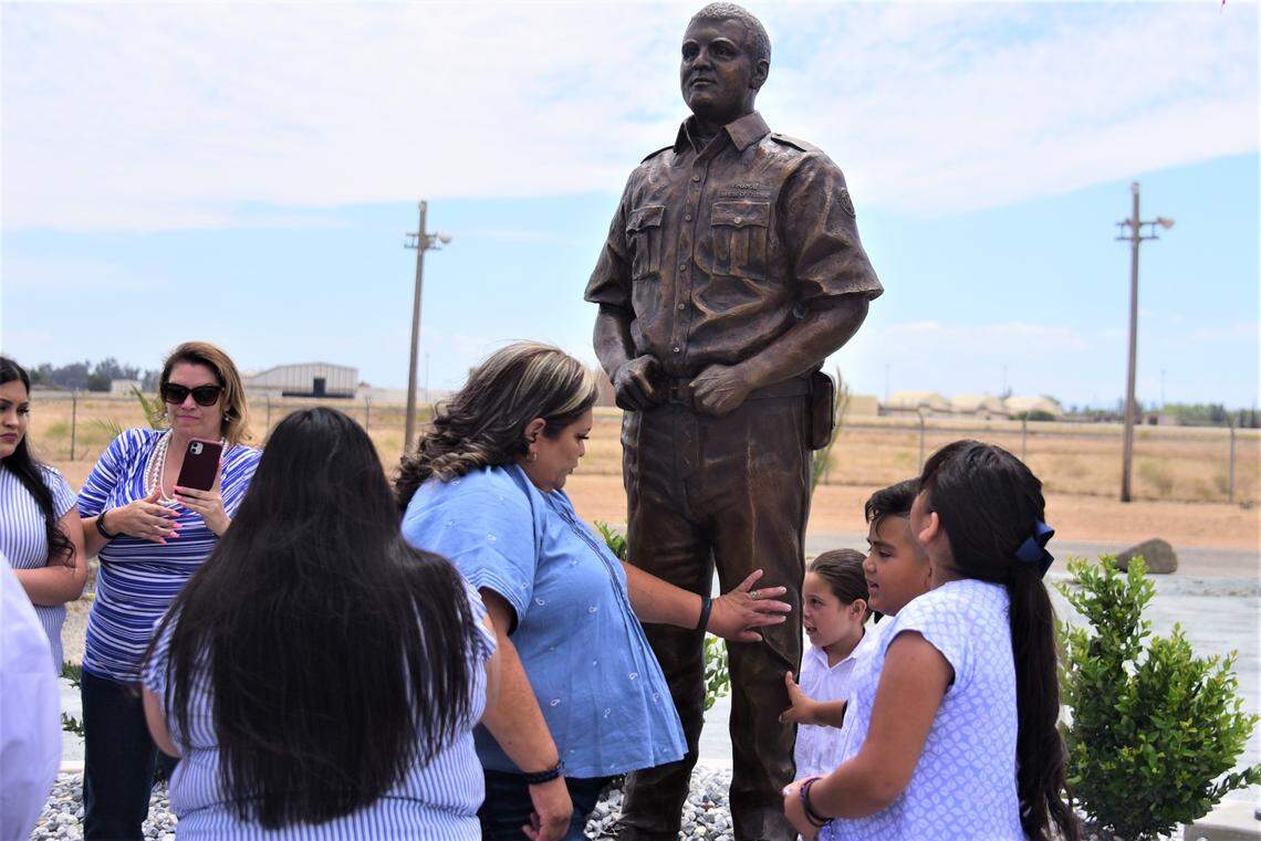 Terry Rivera touches the statue that honors her son Jose V. Rivera, a former correction officer that was killed in the line of duty in 2008. The memorial statue was unveiled during a ceremony on Friday, June 17, 2022 at the Jose V. Rivera Memorial Park located near the United States Penitentiary in Atwater, Calif.