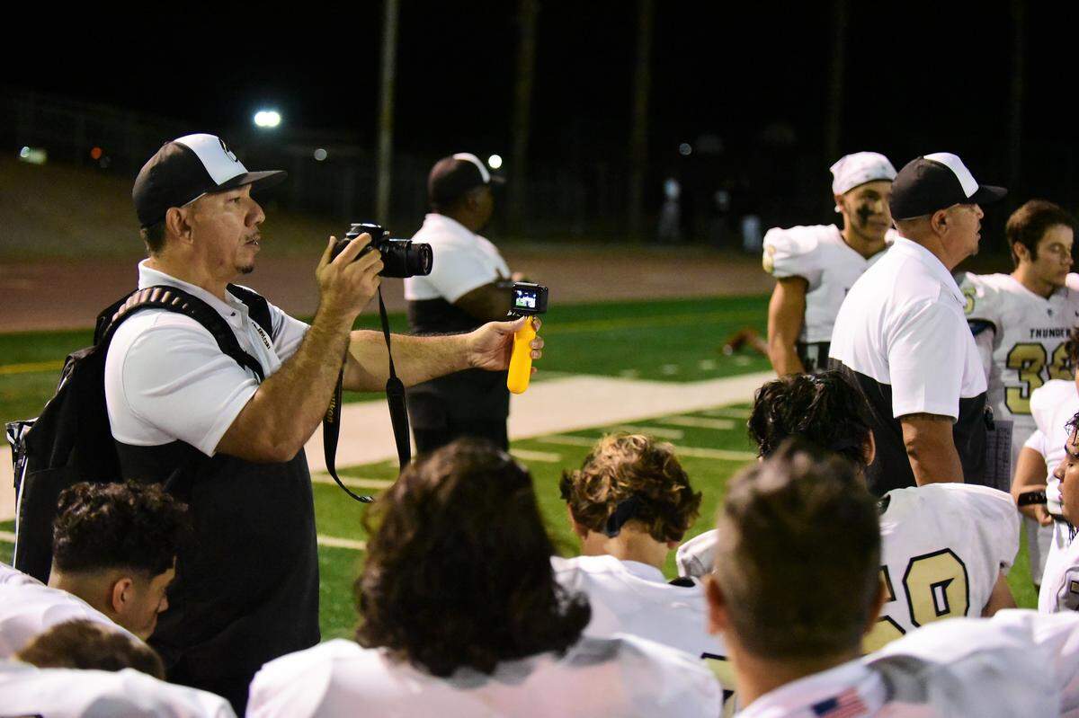 Keith Ducey is working two cameras to get postgame footage after Buhach Colony defeated Patterson 37-21 on Friday, Sept. 20, 2019 at Patterson High.