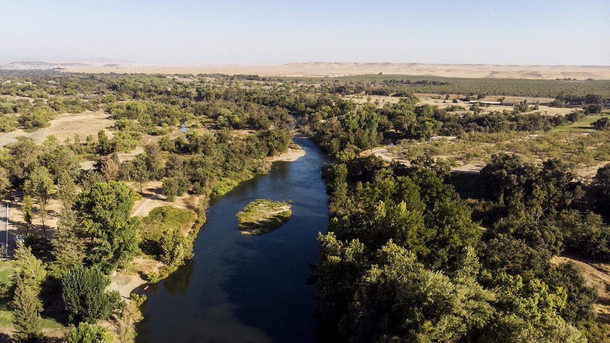 The Merced River is seen flowing past Henderson Park in Snelling Calif., on Friday, Sept. 21, 2018. 