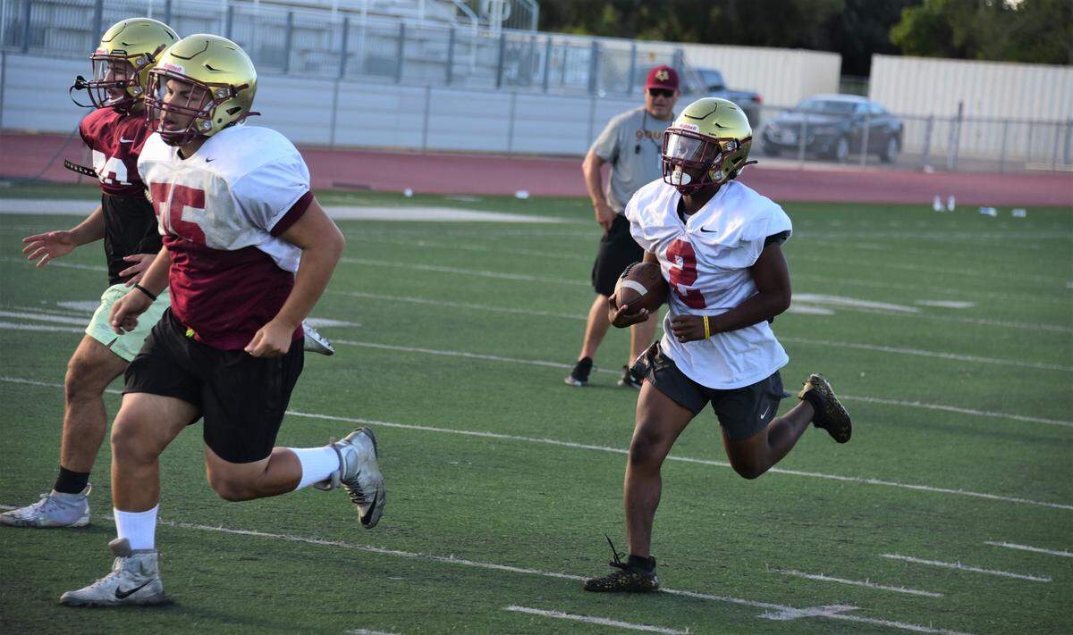 Golden Valley High School senior running back Jahkylle Smith runs the ball during practice on Tuesday, Aug. 9, 2022 at Veterans Stadium in Merced, Calif.