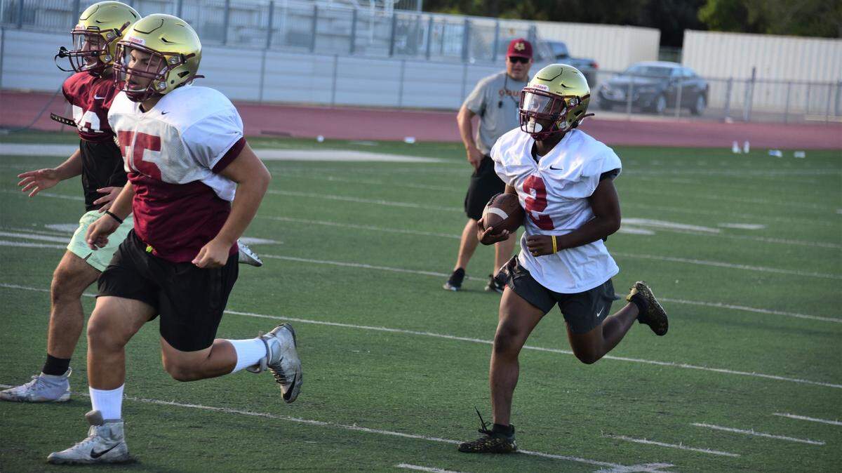 Golden Valley High School senior running back Jahkylle Smith runs the ball during practice on Tuesday, Aug. 9, 2022 at Veterans Stadium in Merced, Calif.