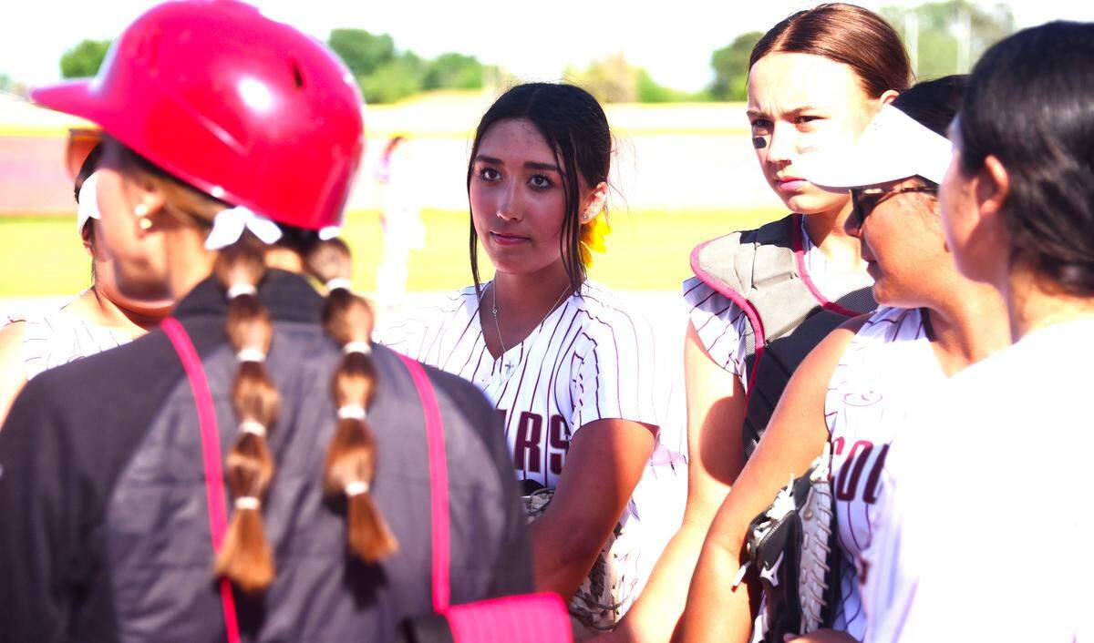 Golden Valley High senior Bree Barner, center, chats with teammates during a game against Patterson on Friday, April 20, 2024 at Golden Valley High School in Merced, Calif.