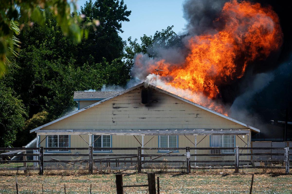 Cal Fire Merced County firefighters and City of Merced firefighters battle a structure fire which damaged two homes in the 1800 block of Dunn Road in Merced County, Calif., on Wednesday, Aug. 23, 2023. Fire officials said the cause of the fire is under investigation.