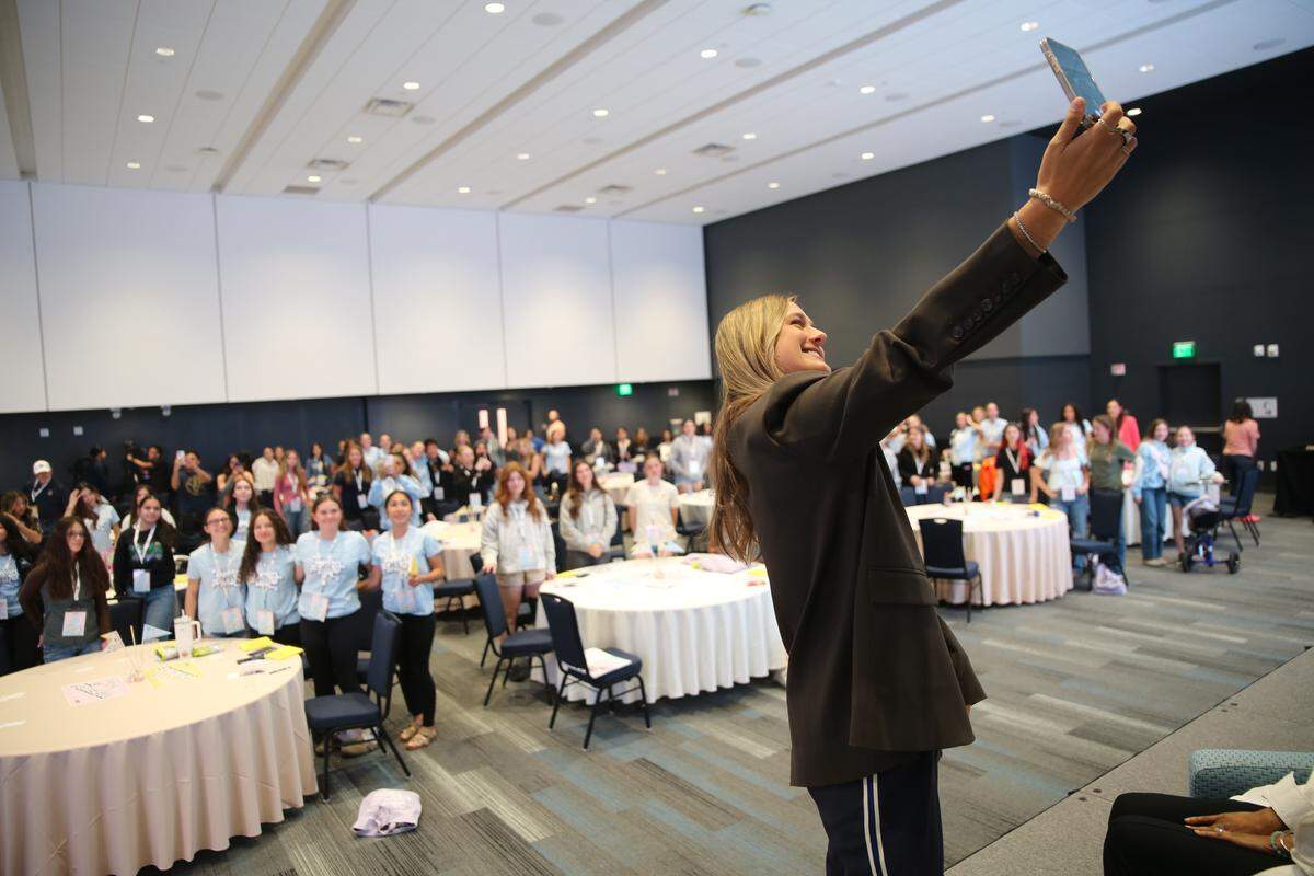 Victoria Garrick Browne, a mental health advocate, takes a selfie with participants from the “Together We Will” conference at UC Merced on Sunday, March 8, 2026.