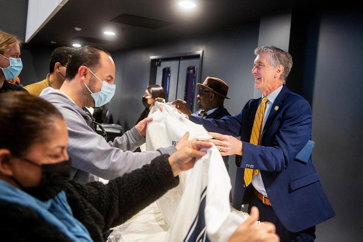 University of California, Merced Vice Chancellor for Student Affairs Charles Nies, right, hands out shirts to those in attendance during a 20-year anniversary celebration of the groundbreaking of the University of California, Merced, in Merced, Calif., on Wednesday, Jan. 25, 2023.