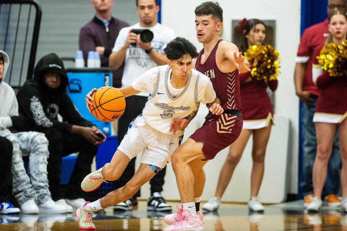 Atwater senior Nicholas Trejo (3) dribbles around Golden Valley senior Ricardo Perez (3) during a game at Atwater High School in Atwater, Calif., on Monday, Jan. 29, 2024.
