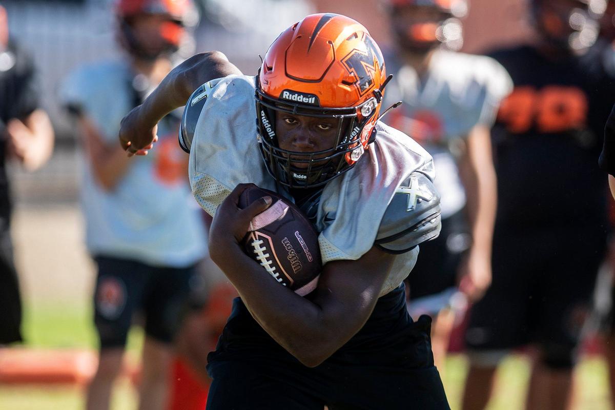 Cammarri Jackson runs the ball during football practice at Merced High School in Merced, Calif., on Monday, Aug. 19, 2024.