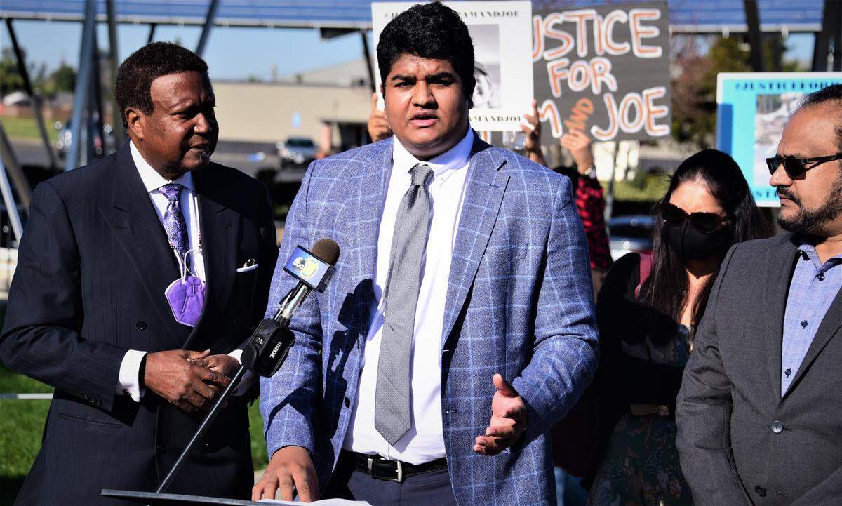 King Vanga, 20, speaks during a press conference held in front of Atwater City Hall with his attorney John Burris on his left on Friday, Dec. 10, 2021 in Atwater, Calif.