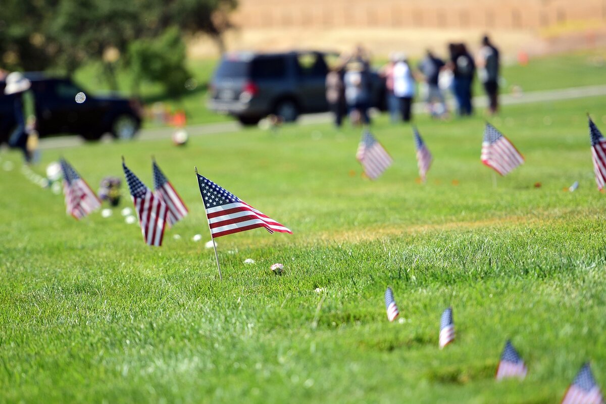 Flags wave over rows of grave markers on Sunday, May 27, 2018, at San Joaquin Valley National Cemetery in Santa Nella following a ceremony for Memorial Day.
