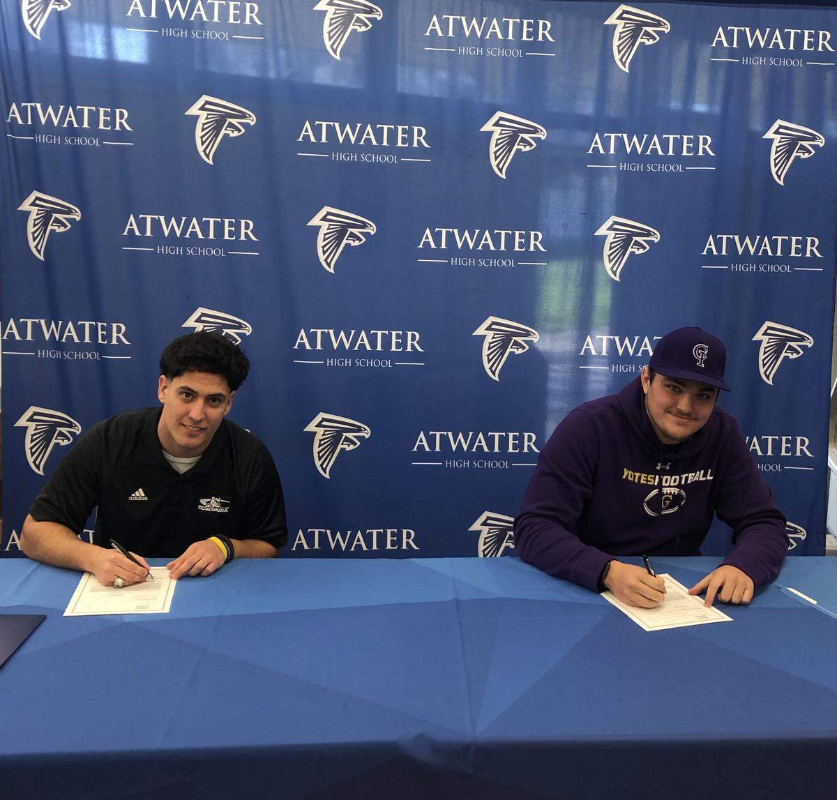 Atwater High football players Nate Moore (left) and Sam Jenkins (right) sign their national letters of intent to accept football scholarships on Wednesday morning. Moore is headed to Concordia University in Nebraska and Jenkins will play at the College of Idaho.
