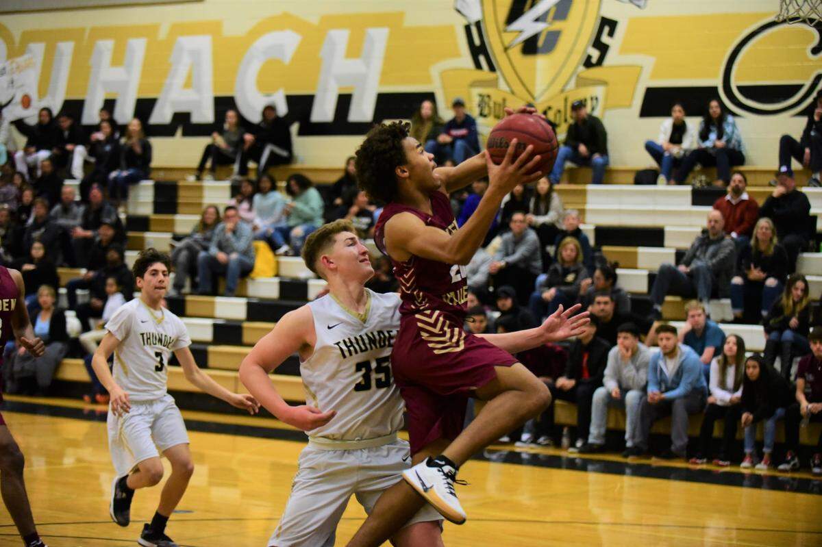 Golden Valley senior Avery Townsel goes up for a layup against Buhach Colony’s Jake Sapien during a game on Friday, Jan. 17, 2020 at Buhach Colony High School.