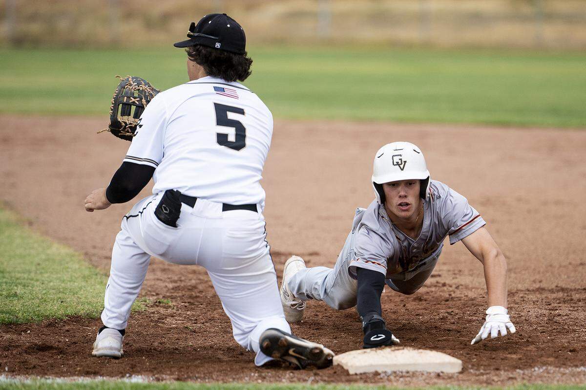 Golden Valley junior Koen Heupel (6) dives back to first base on a Buhach Colony pickoff attempt during a game at Buhach Colony High School in Atwater, Calif., on Thursday, May 4, 2023.