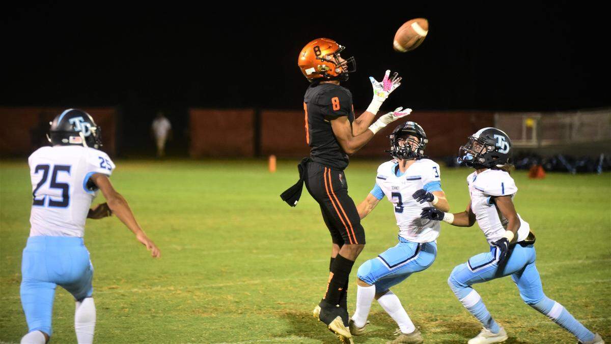 Merced High School receiver Enoch Evans leaps for a 30-yard reception against Downey on Friday, Sept. 2, 2022 at Cathie Hostetler Stadium.