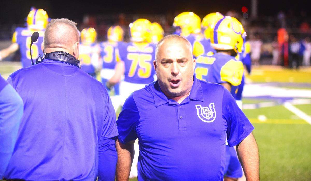 Dos Palos High School football coach Rob Calvert reacts after the Broncos’ seal a 21-20 victory over Coalinga after a late interception on Friday, Oct. 28, 2023.