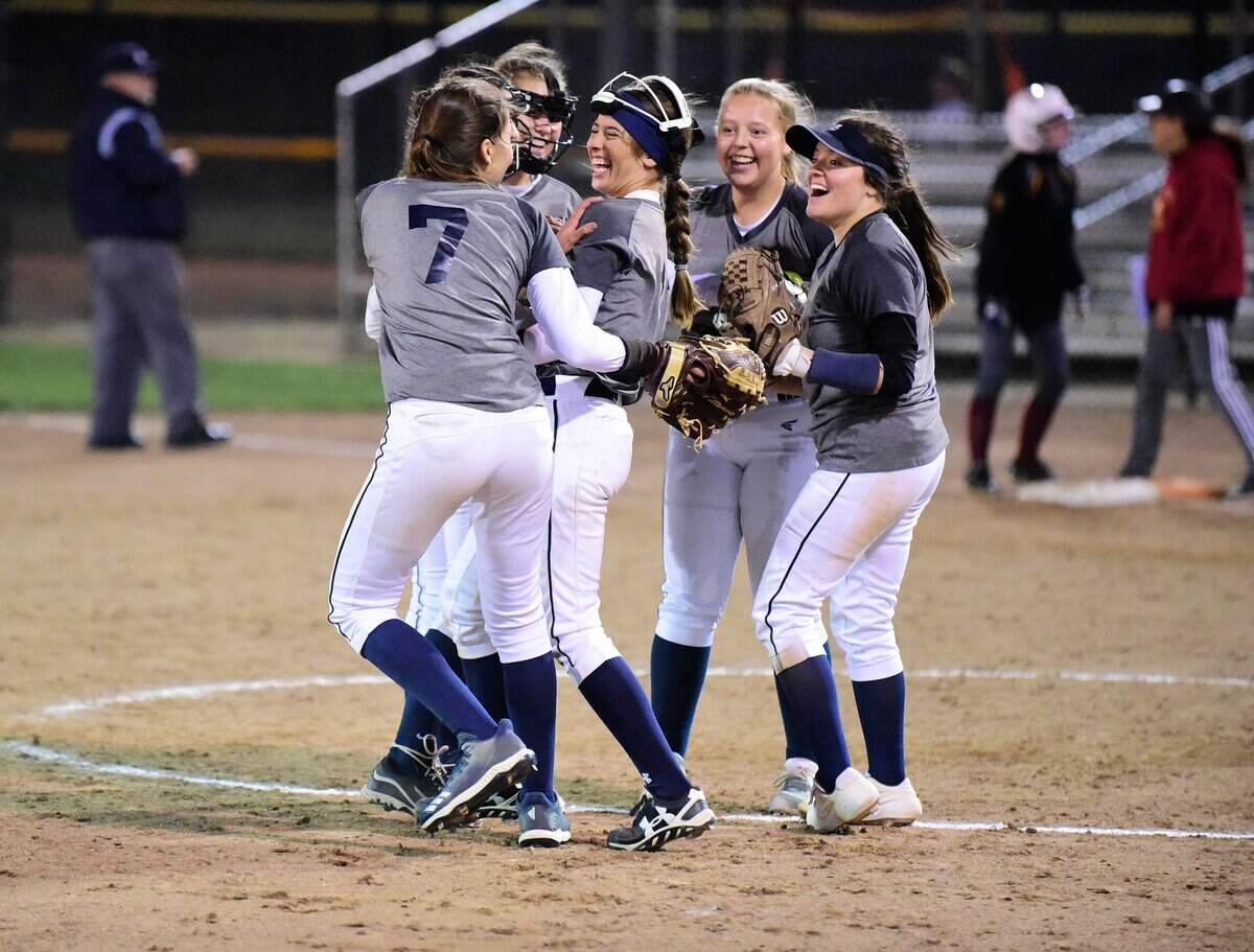 The Stone Ridge Christian players celebrate a diving play by shortstop Caitlyn Cole (center) during the Knights’ 4-1 win over Forest Hill Christian on Tuesday, May 21, 2019.