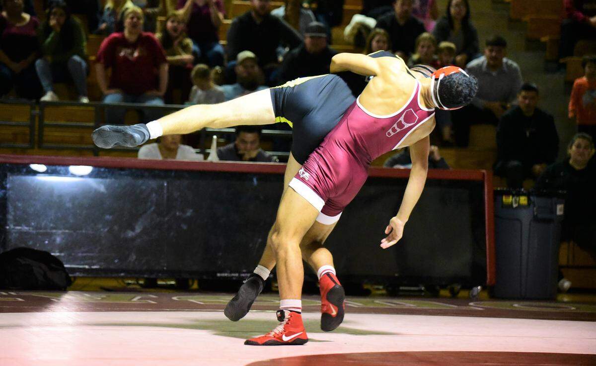 Golden Valley senior Willie Ward-Williams throws El Capitan’s Zachary Haase Jr. to the mat during their 154-pound match on Tuesday, Jan. 28, 2020 at Cougar Arena.