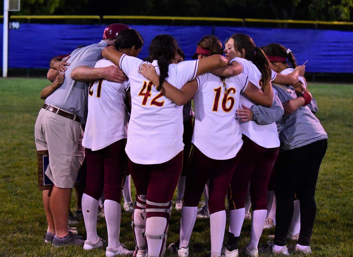 The Golden Valley High softball team gathers for a group hug after losing to Oakdale 12-2 in the Sac-Joaquin Section Division III championship on Thursday, May 23, 2019 at the Arnaiz Softball Complex in Stockton, Calif.