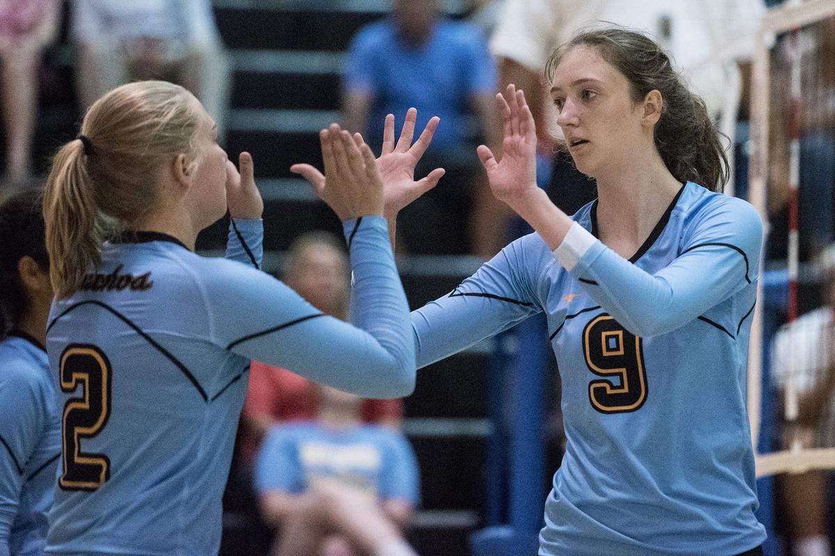 El Capitan seniors Robin Helms (9) and Mikayla Kaufhardt (2) high-five during a match against Atwater at El Capitan High School in Merced, Calif., on Wednesday, Aug. 29, 2018. The Gauchos beat the Falcons 3-0.