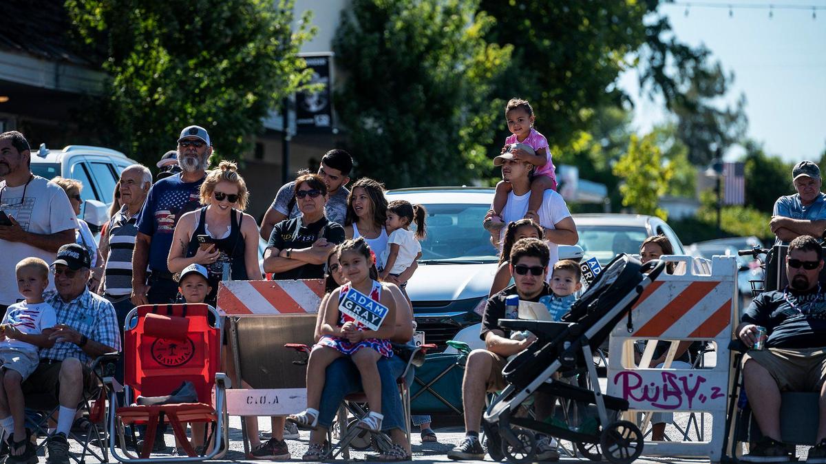 People look on during a Fourth of July parade in Atwater, Calif., on Monday, July 4, 2022.