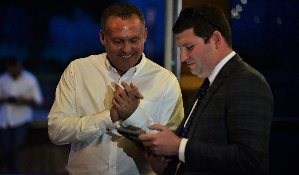 Democrat Adam Gray reacts after receiving a 13th Congressional District primary election results update from campaign volunteer Adam Capper during Gray’s election night viewing party at The Tarmac in Atwater, Calif. on Tuesday, June 7, 2022.