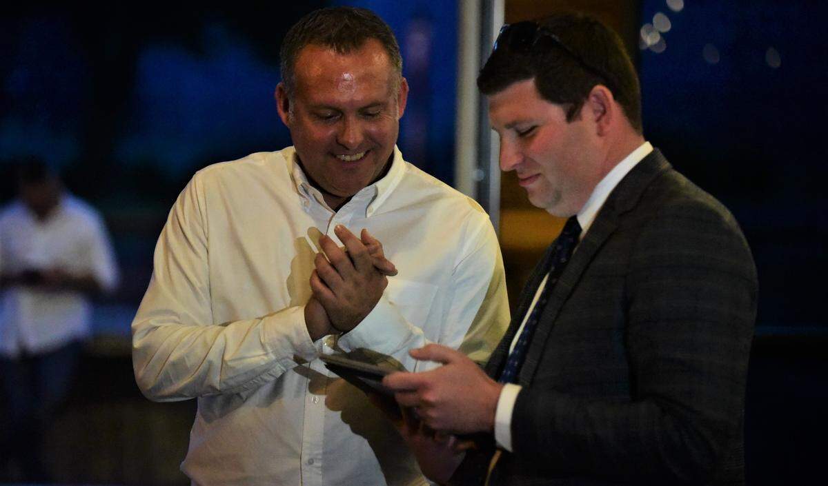 Democrat Adam Gray reacts after receiving a 13th Congressional District primary election results update from campaign volunteer Adam Capper during Gray’s election night viewing party at The Tarmac in Atwater, Calif. on Tuesday, June 7, 2022.