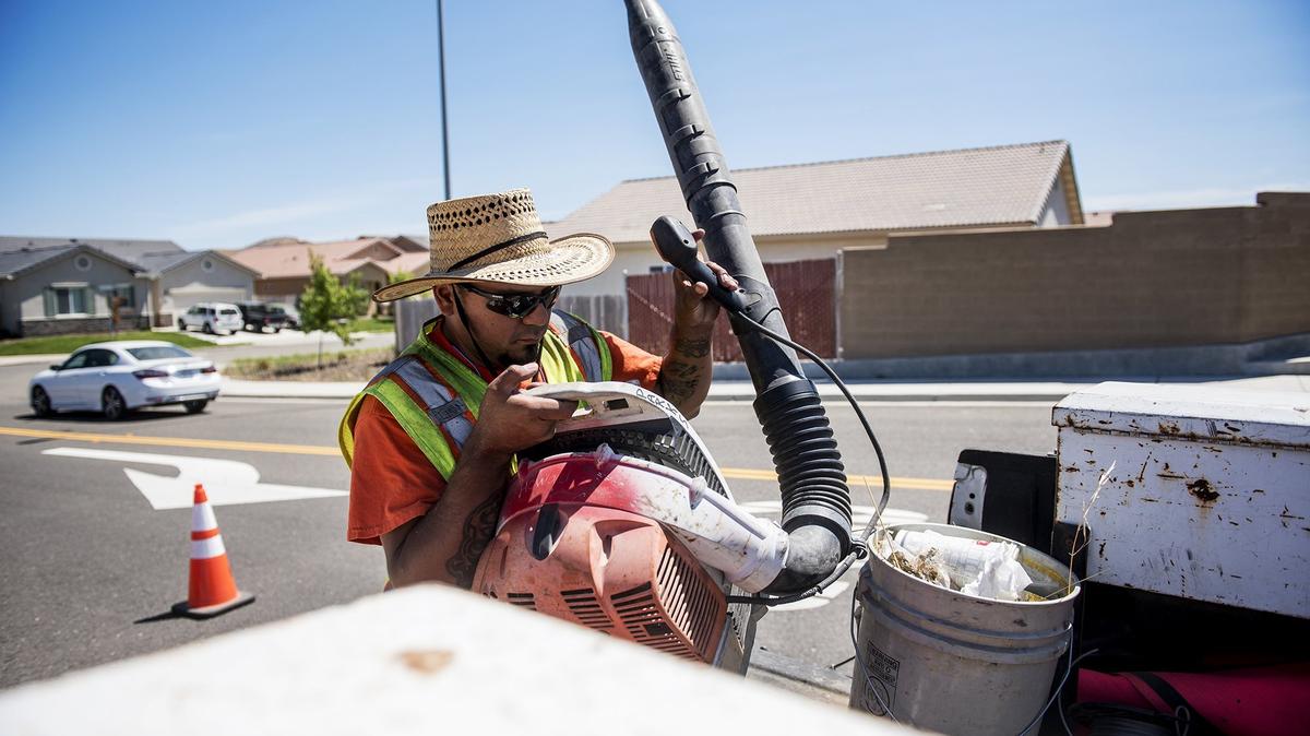 City of Atwater Public Works employee, John Linan, 35, of Atwater, places a leaf blower in the back of a city truck in Atwater, Calif., on Wednesday, June 27, 2018.