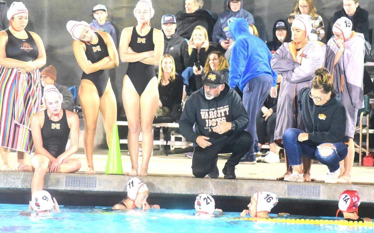 Merced High School girls water polo coach Kit Grattan speaks to his team during a timeout during a semifinal game against El Capitan on Tuesday, Nov. 7, 2023,