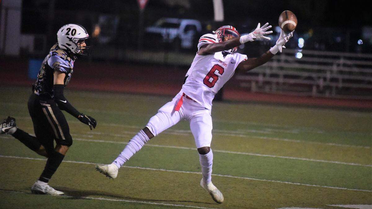 Lincoln receiver Ezriel Vasquez tries to bring down a pass as Buhach Colony’s Jonathan Silva defends during a game on Friday, Sept. 10, 2021 at Dave Honey Stadium in Atwater, Calif.