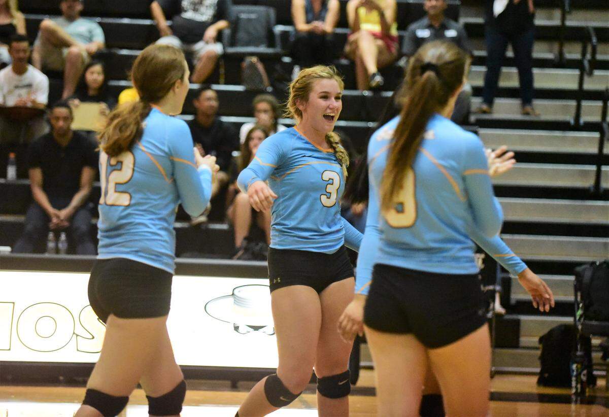 El Capitan’s Roosmarie Van Der Weide (12), Natalie Collins (3) and Sara Johnson (9) celebrate a point against Buhach Colony on Wednesday, Sept. 25, 2019. 