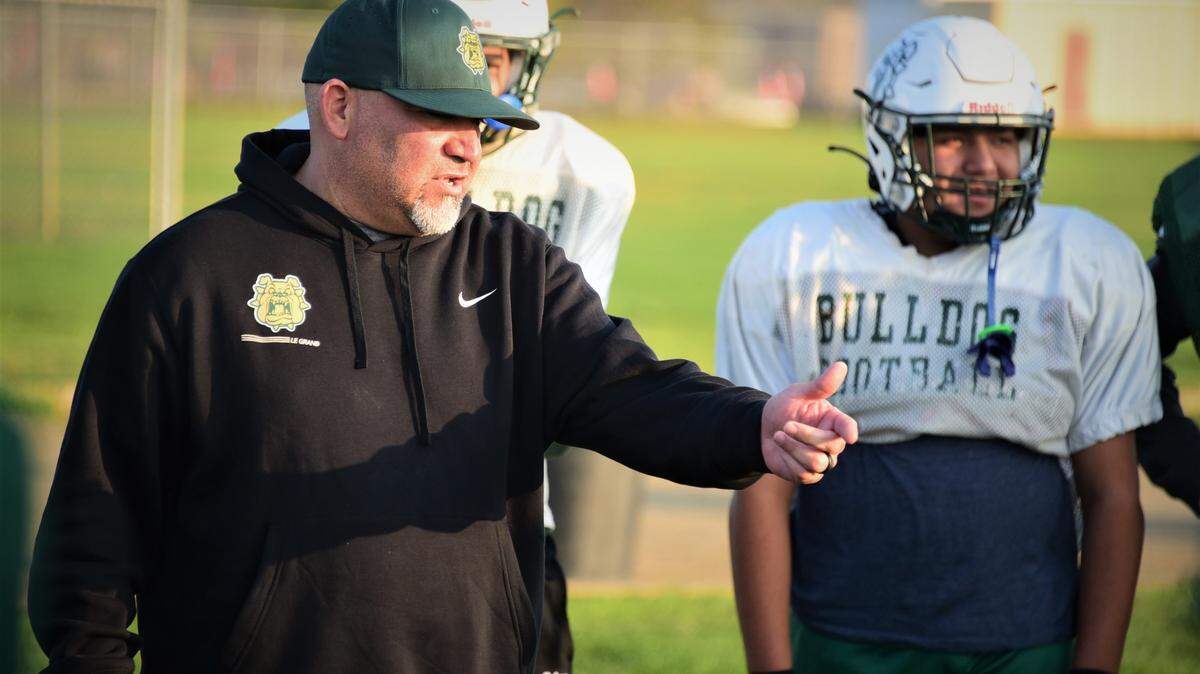 Le Grand High head coach Aaron Martinez talks to his players during practice on Wednesday, Nov. 24, 2021 in Le Grand, Calif. The Bulldogs will play Woodland Christian for the Sac-Joaquin Section Division VII championship on Friday afternoon.
