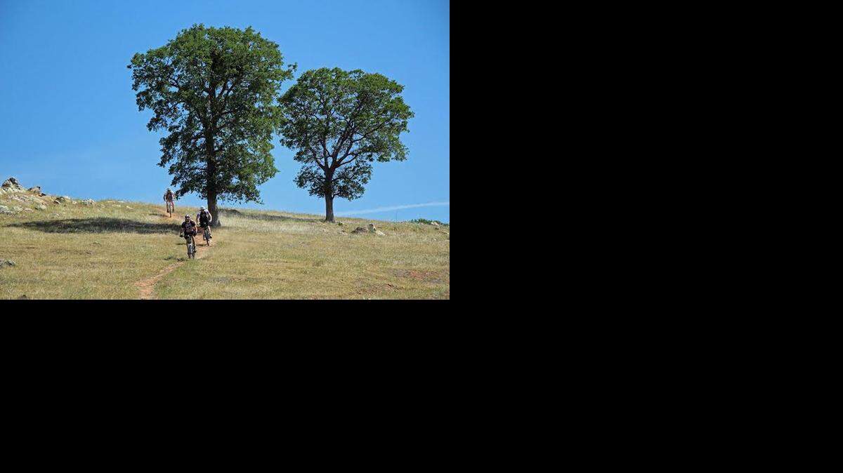 Bike riders make their descent from the Barrett Summit. On Saturday, the new Exchequer Mountain Bike Park at Lake McClure will open.
