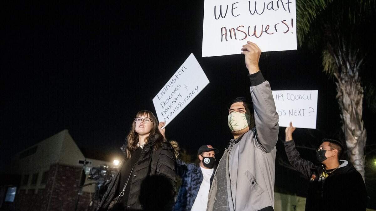 Livingston resident Rafael, 29, holds a sign demanding answers from elected officials during a call to action protest outside Livingston City Hall in Livingston, Calif., on Thursday, Nov. 18, 2021. Livingston Police Chief John Markle, was recently placed on administrative leave by Interim City Manager Vanessa Portillo.