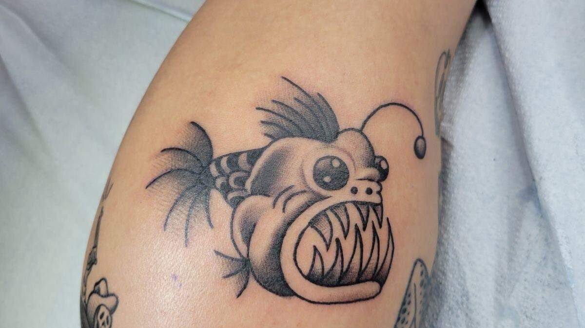 Tatto of a cartoon anglerfish on client’s calf by Main Street Tattoo and Body Piercing artist, Ed Garcia. Courtesy of Ed Garcia.