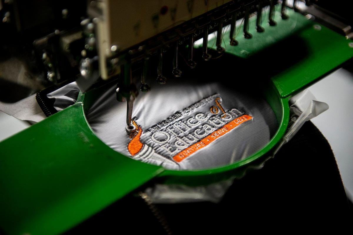 Clothing is embroidered at McNamara Sports, located at 437 W. 18th Street in Merced, Calif., on Monday, May 8, 2023. The family owned store which sells athletic equipment, team uniforms, business apparel and offers screen printing and embroidery services, is celebrating 100 years in business