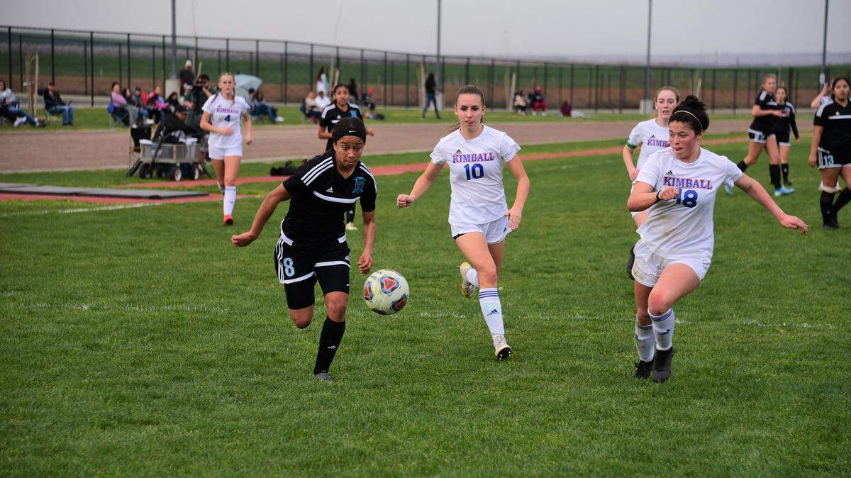 El Capitan High sophomore Anaya Shelton races for the ball against Kimball players Sarah Perdue (10) and Allyson Thompson (18) during a playoff match on Friday, Feb. 21, 2020.
