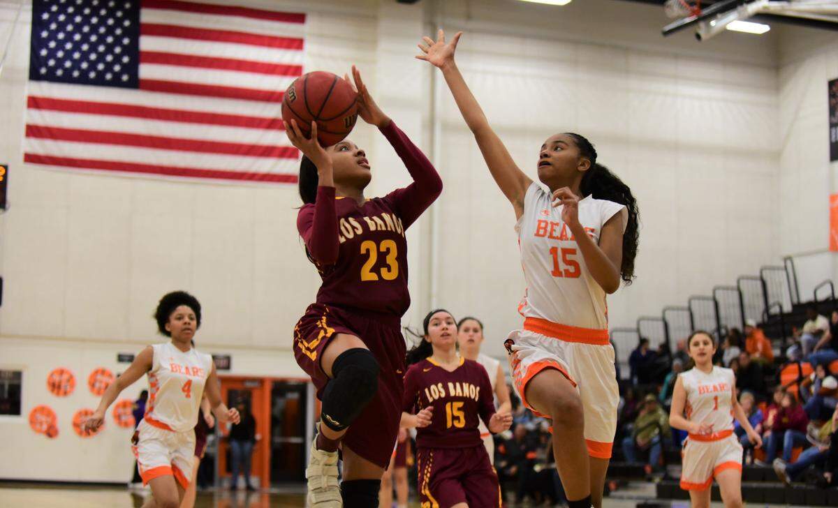 Los Banos senior Sienna Hampton goes up for a layup against Merced’s Anaya Seals during a playoff game at Merced High School on Tuesday, Feb. 18, 2020.