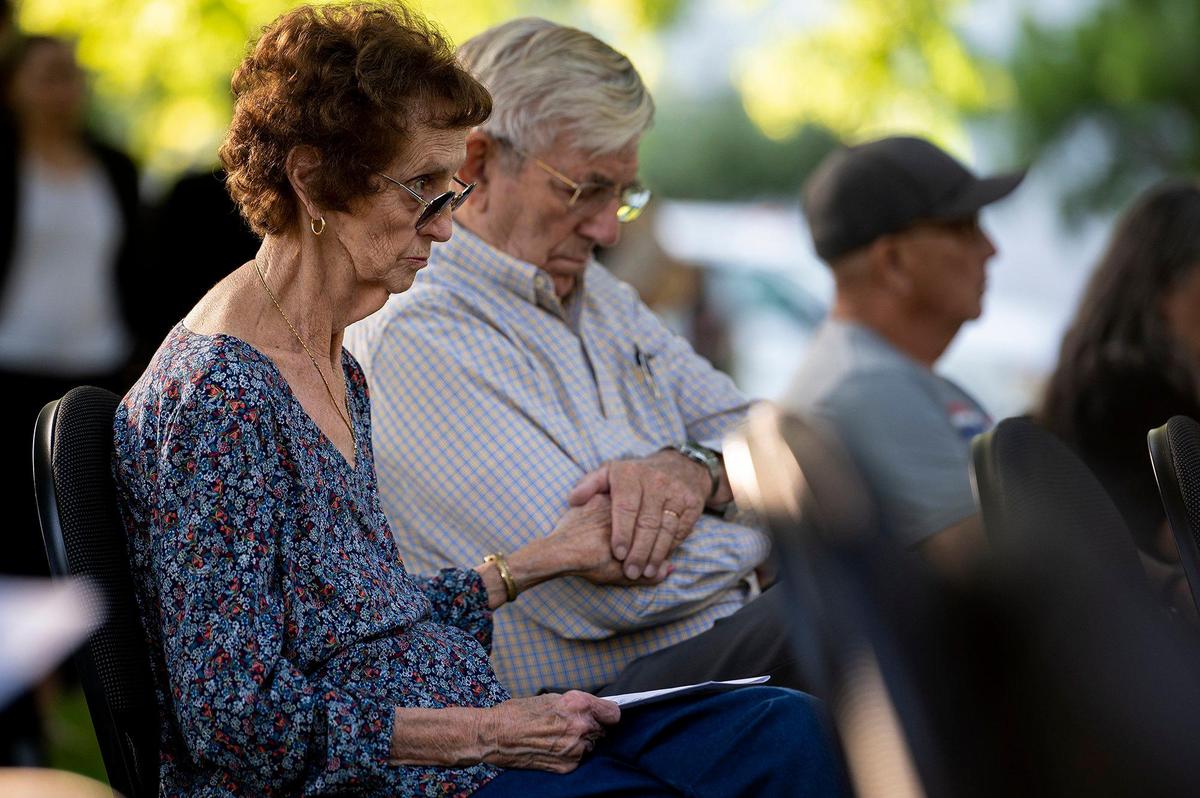 Jean Hoover looks on as her husband Dale holds her hand during the annual Victims’ Rights Ceremony at Courthouse Park in Merced, Calif., on Tuesday, April 26, 2022.