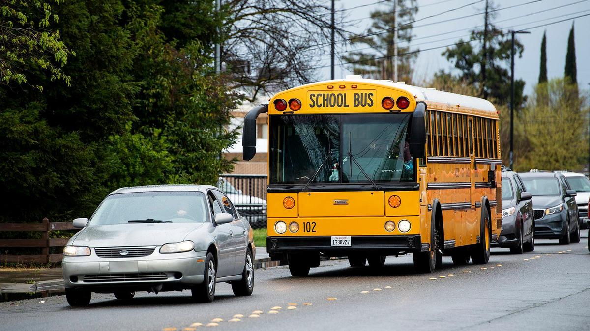 Students are picked up and bused from Burbank Elementary School in Merced, Calif., on Monday, March 16, 2020.
