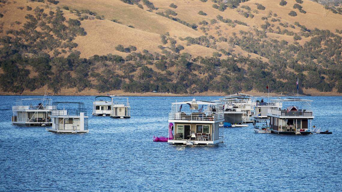 House boats float near McClure Point before the Lights on the Lake Fireworks Celebration at Lake McClure in La Grange, Calif., on Saturday, June 29, 2019.