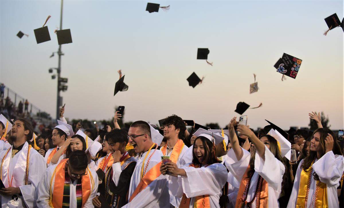 Merced High School graduates toss their caps in the air at the conclusion of school’s graduation ceremony on Thursday, June 1, 2023.