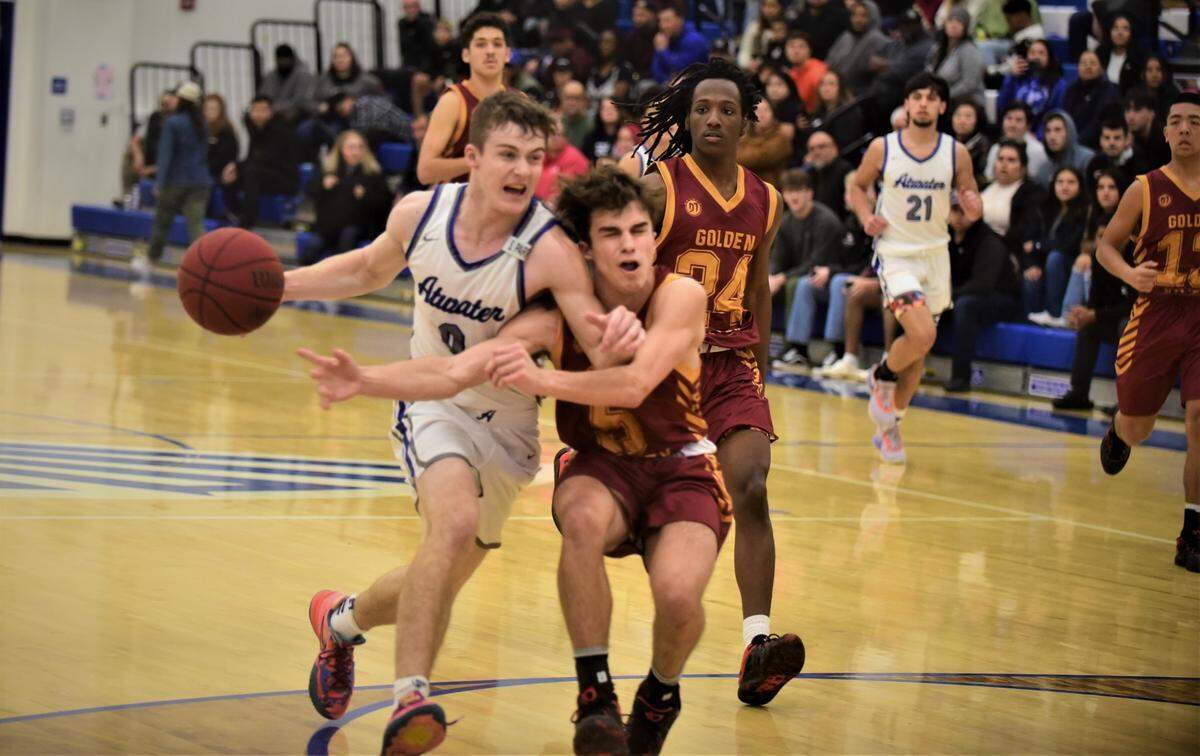 Atwater High senior Colton Dukes (0) is fouled by Golden Valley’s Joseph Spielman (5) while driving to the basket during a game on Friday, January 6, 2022 at Atwater High School.