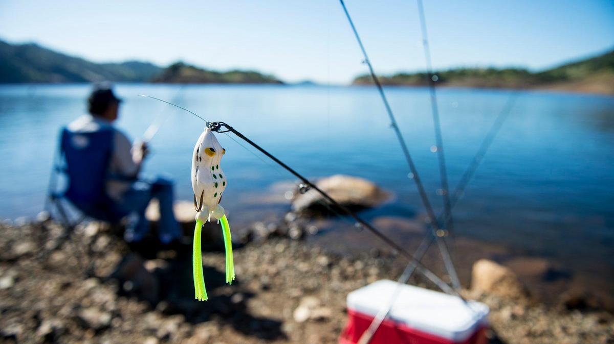 A lure hangs from the end of a line as Atwater resident Lester Yamaguchi, 68, fishes for trout during the 2017 Spring Trout Derby in the Barrett Cove area of Lake McClure in Mariposa County, Calif., on Saturday, April 29, 2017. The Merced Irrigation District announced Monday, that is has stocked more than 150,000 pounds of trout to Lake McClure.