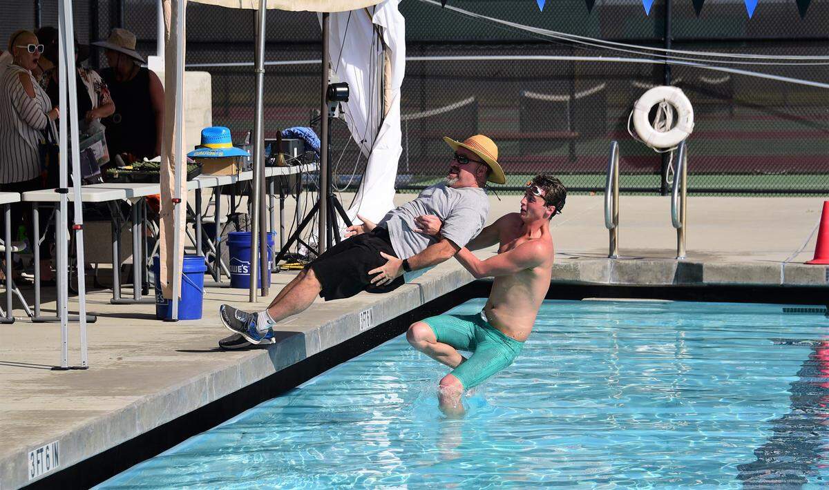 Merced High senior Nick Eckles pulls Bears assistant swimming coach Stephen Eccles into the pool as the Bears celebrate a Central California Conference championship at Thursday’s CCC championships at El Capitan High.